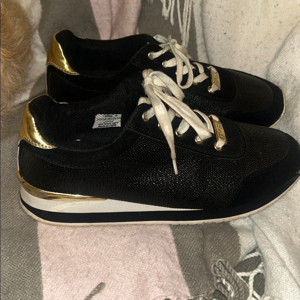 Bebe sporty gold black and white tennis shoes. Condition is pre owned. Size 10